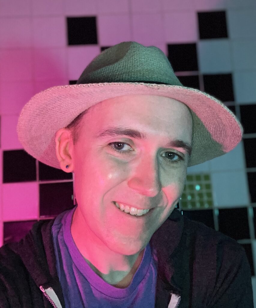 Picture of Aeon Bliss in pink and blue lighting with tile background